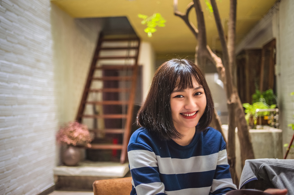 Smiling Woman in Blue and White Striped Shirt